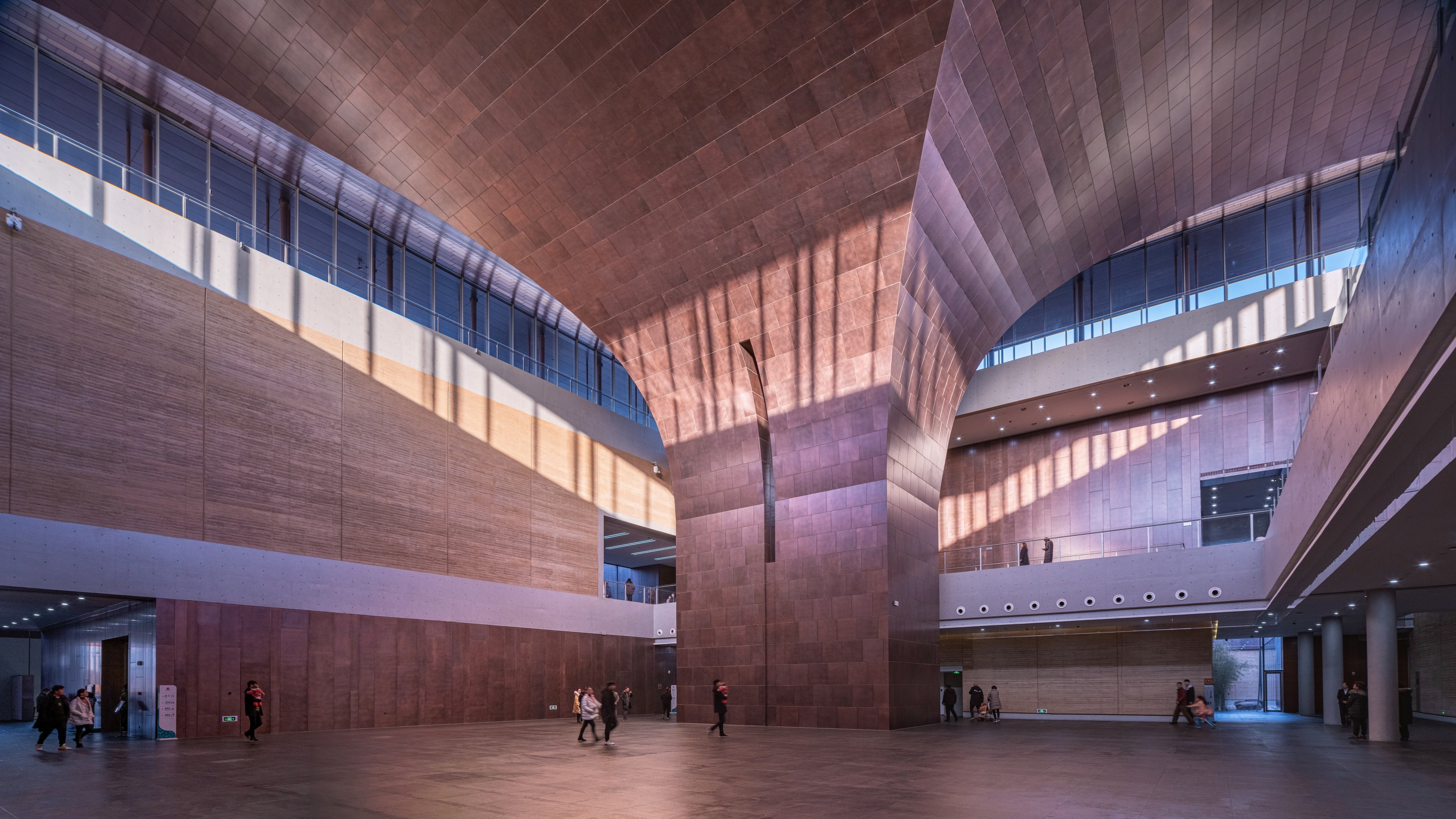Copper-toned interior cladding in the tall central hall of the Erlitou Site Museum