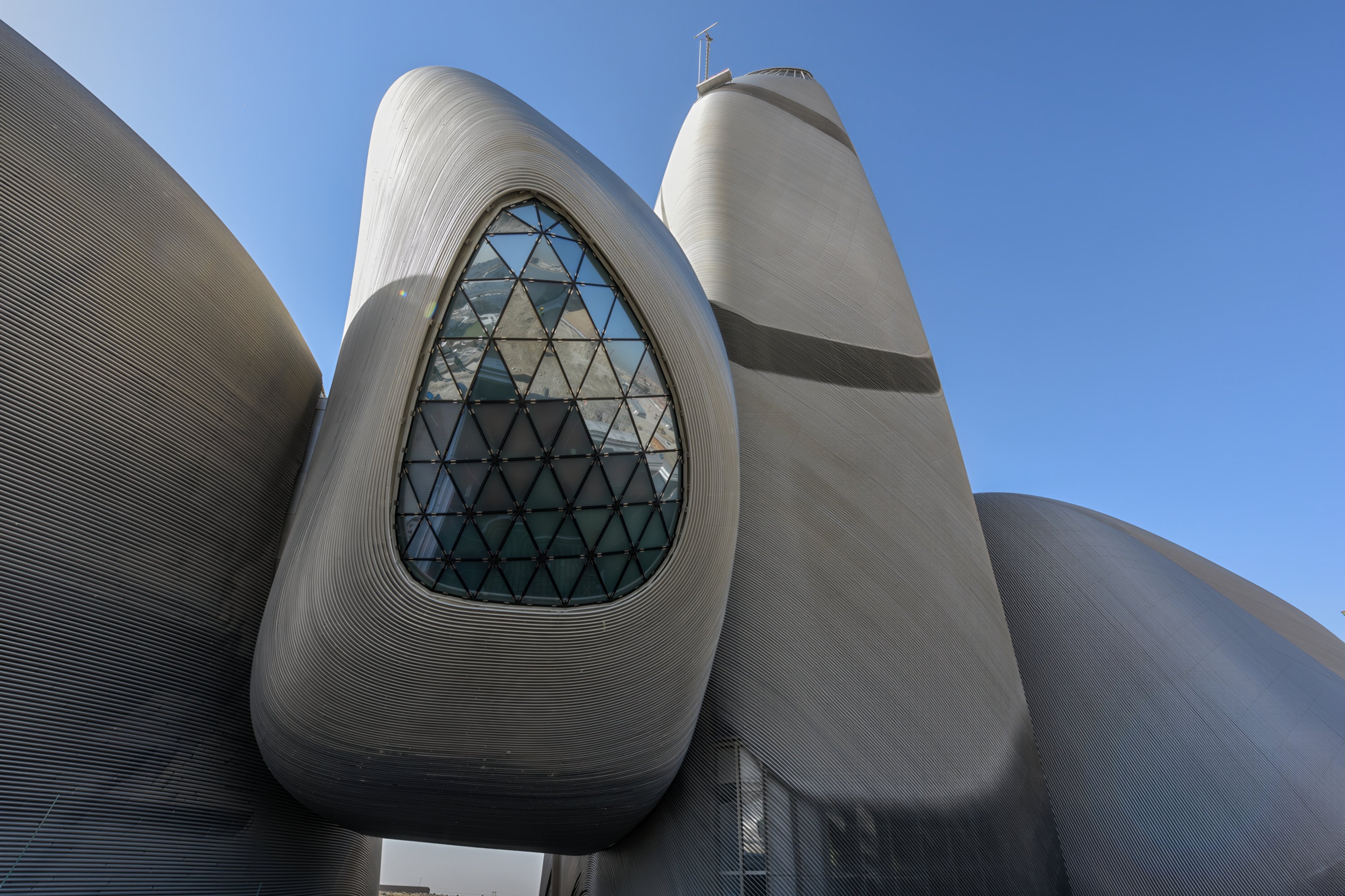 The curved metal-clad towers and glazed opening of Ithra in Dhahran
