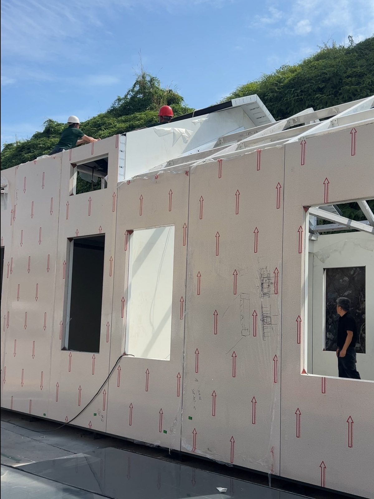 Roof framing and membrane being fixed over the panelised walls