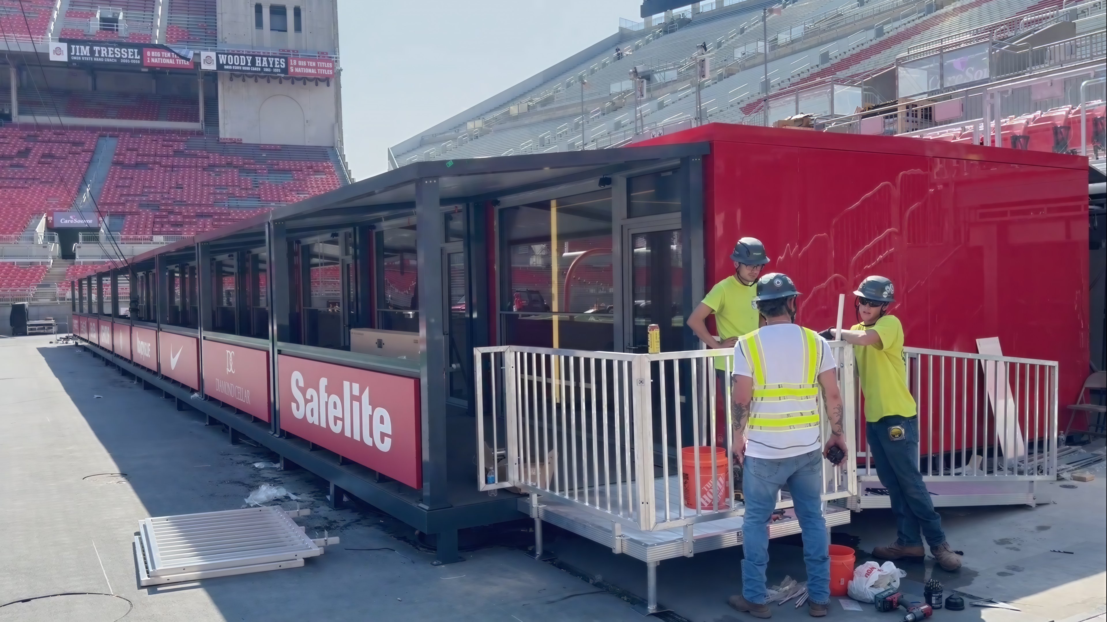 Installation crew working beside Style C VIP suites at a stadium