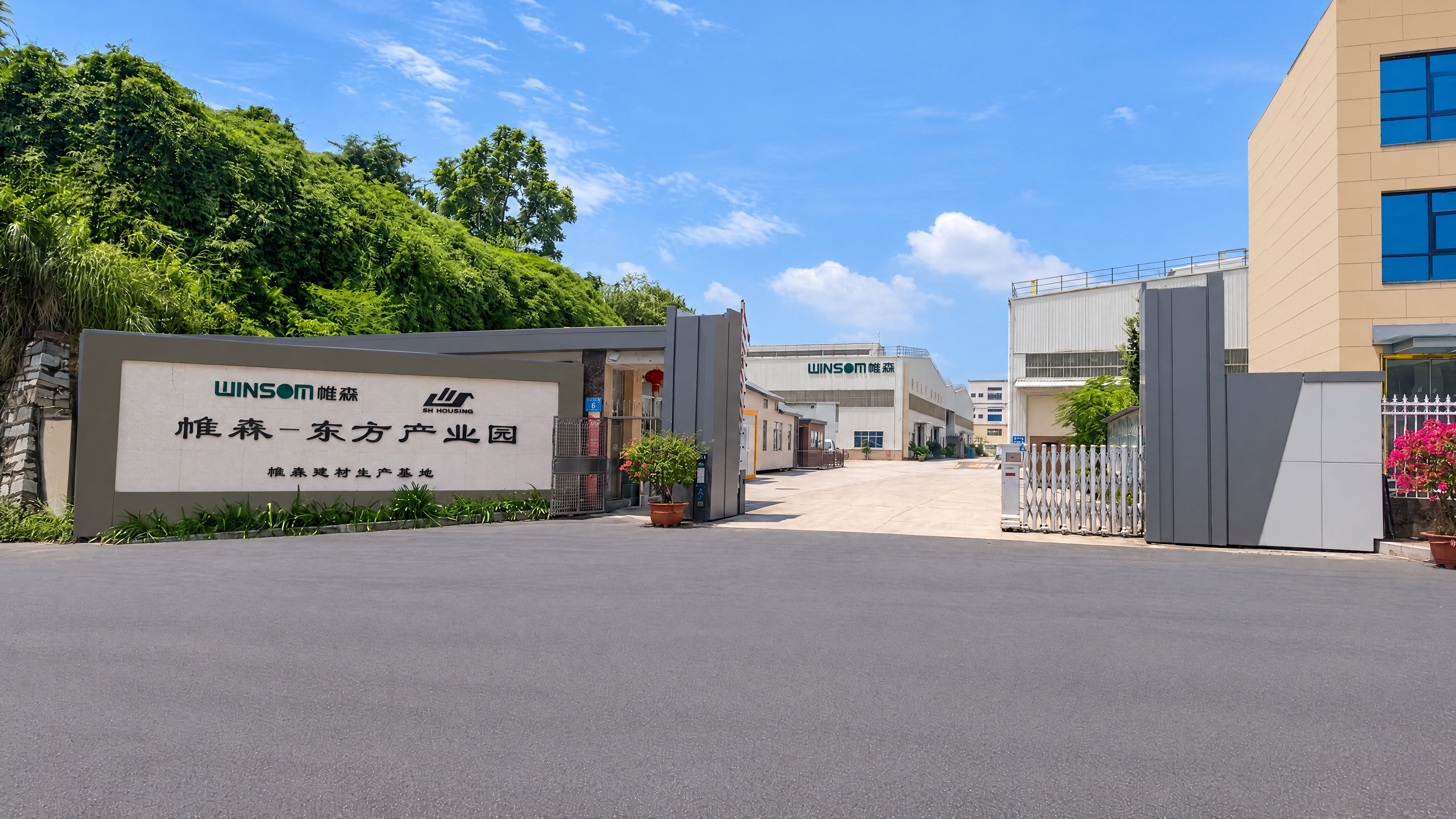 Winsom company entrance with the company sign, open gate and factory buildings